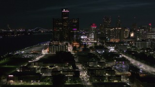 5.7K aerial stock footage GM Renaissance Center and brightly lit skyscrapers at night, Downtown Detroit, Michigan Aerial Stock Footage | DX0002_198_039