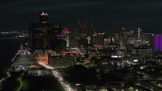 5.7K aerial stock footage approach and flyby GM Renaissance Center and skyscrapers from river at night, Downtown Detroit, Michigan Aerial Stock Footage | DX0002_198_045