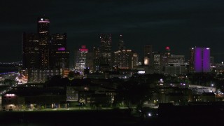 5.7K aerial stock footage ascend and approach the skyline at night, Downtown Detroit, Michigan Aerial Stock Footage | DX0002_198_049