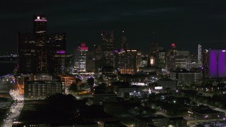 5.7K aerial stock footage ascend and fly away from the skyline at night, Downtown Detroit, Michigan Aerial Stock Footage | DX0002_198_050