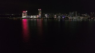 DX0002_199_004 - 5.7K aerial stock footage focus on hotel and casino across the river while descending at nighttime, Windsor, Ontario, Canada