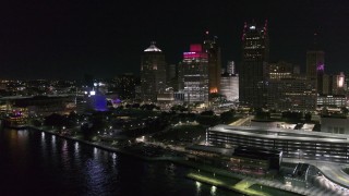 DX0002_199_009 - 5.7K aerial stock footage approach and orbit towering skyscrapers and Hart Plaza at night, Downtown Detroit, Michigan