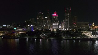 DX0002_199_012 - 5.7K aerial stock footage stationary view of Hart Plaza and towering skyscrapers at night, Downtown Detroit, Michigan