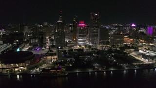 DX0002_199_018 - 5.7K aerial stock footage orbit Hart Plaza and nearby skyscrapers at night, seen from the river, Downtown Detroit, Michigan