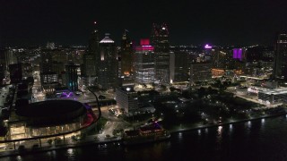 DX0002_199_019 - 5.7K aerial stock footage slowly orbit Hart Plaza and skyscrapers at night, seen from the river, Downtown Detroit, Michigan