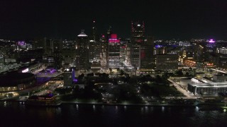 DX0002_199_020 - 5.7K aerial stock footage of circling Hart Plaza and skyscrapers at night, seen from the river, Downtown Detroit, Michigan