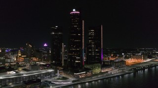 5.7K aerial stock footage fly away from and orbit GM Renaissance Center by the river at night, Downtown Detroit, Michigan Aerial Stock Footage | DX0002_199_028