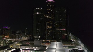 DX0002_199_030 - 5.7K aerial stock footage focus on GM Renaissance Center during descent at night, Downtown Detroit, Michigan