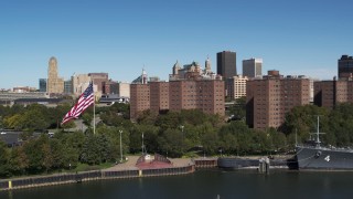 5.7K aerial stock footage flying away from Downtown Buffalo and apartment complex, reveal warship, New York Aerial Stock Footage | DX0002_200_001