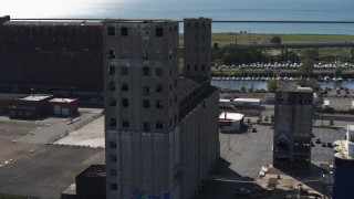 DX0002_201_024 - 5.7K aerial stock footage of circling around a large grain elevator in Buffalo, New York