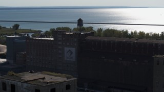 5.7K aerial stock footage of a water tower on a flour mill in Buffalo, New York Aerial Stock Footage | DX0002_201_036