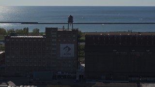 5.7K aerial stock footage of circling a water tower on a flour mill in Buffalo, New York Aerial Stock Footage | DX0002_201_038