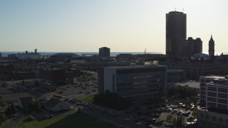 5.7K aerial stock footage of a skyscraper seen while passing police station in Downtown Buffalo, New York Aerial Stock Footage | DX0002_203_011