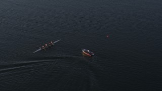 DX0002_203_035 - GLITCH 5.7K aerial stock footage ascend and approach a rowboat and speedboat at sunset, Buffalo, New York