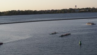 DX0002_203_044 - 5.7K aerial stock footage of rowboats on Lake Erie at sunset, Buffalo, New York