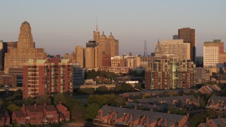 DX0002_204_004 - 5.7K aerial stock footage of city hall, courthouse and office buildings seen from condos at sunset, Downtown Buffalo, New York