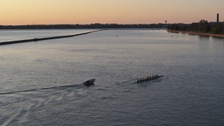 5.7K aerial stock footage of passing a rowboat and speedboat on Lake Erie at sunset, Buffalo, New York Aerial Stock Footage | DX0002_204_012