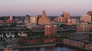 DX0002_204_023 - 5.7K aerial stock footage of city hall, courthouse and office buildings at sunset, Downtown Buffalo, New York