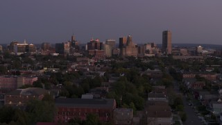 5.7K aerial stock footage of the skyline seen while descending near apartments at twilight, Downtown Buffalo, New York Aerial Stock Footage | DX0002_204_039