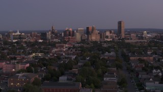 5.7K aerial stock footage of descending past the skyline seen from apartments and homes at twilight, Downtown Buffalo, New York Aerial Stock Footage | DX0002_204_042