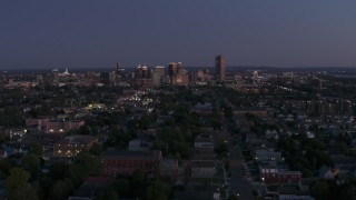 5.7K aerial stock footage of the skyline while passing by apartments and homes at twilight, Downtown Buffalo, New York Aerial Stock Footage | DX0002_204_044