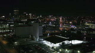 DX0002_205_007 - 5.7K aerial stock footage of flying by grain elevators with a view of the skyline at night, Downtown Buffalo, New York