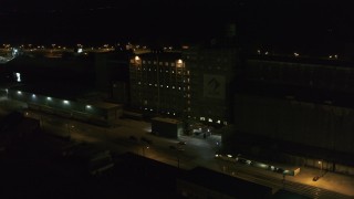 DX0002_205_020 - 5.7K aerial stock footage slowly orbit flour mill at night, Buffalo, New York