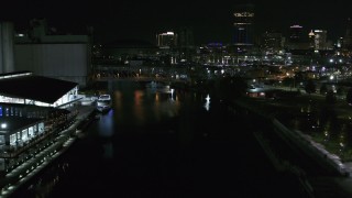 DX0002_205_025 - 5.7K aerial stock footage of flying over the river toward the downtown skyline at night, Downtown Buffalo, New York