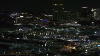 5.7K aerial stock footage of flying by parking lots near the skyscraper at night, Downtown Buffalo, New York Aerial Stock Footage | DX0002_205_032