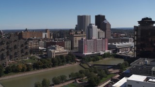 DX0002_206_005 - 5.7K aerial stock footage of riverfront hotels and the city's skyline across the river, Downtown Rochester, New York