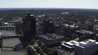 5.7K aerial stock footage stationary view of office buildings by the Genessee River, Downtown Rochester, New York Aerial Stock Footage | DX0002_206_012