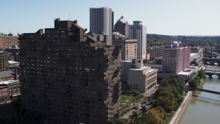 5.7K aerial stock footage orbit riverfront apartment complex and reveal river, Downtown Rochester, New York Aerial Stock Footage | DX0002_206_024