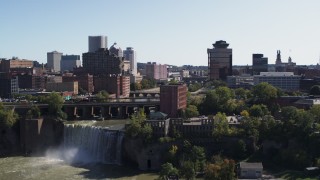 DX0002_206_033 - 5.7K aerial stock footage reverse view of the city's skyline and river, reveal the falls, Downtown Rochester, New York