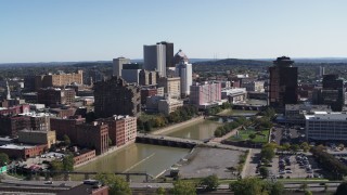 5.7K aerial stock footage of flying by river bridges and skyline, Downtown Rochester, New York Aerial Stock Footage | DX0002_207_005