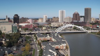 5.7K aerial stock footage of the skyline behind bridge over Genesee River, Downtown Rochester, New York Aerial Stock Footage | DX0002_207_011