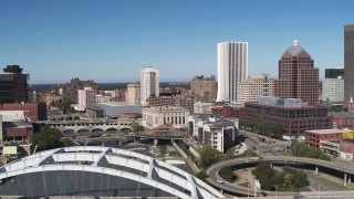 DX0002_207_028 - 5.7K aerial stock footage flyby bridges spanning Genesee River with view of The Metropolitan skyscraper, Downtown Rochester, New York