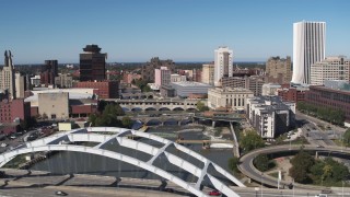 5.7K aerial stock footage fly past bridges over the river and city buildings, Downtown Rochester, New York Aerial Stock Footage | DX0002_207_034