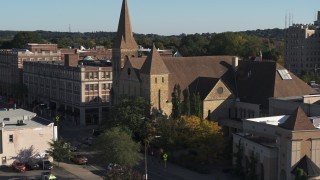 5.7K aerial stock footage orbit and fly away from a church in Rochester, New York Aerial Stock Footage | DX0002_208_024