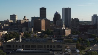 DX0002_209_001 - 5.7K aerial stock footage of skyscrapers and office towers behind apartment building, Downtown Rochester, New York