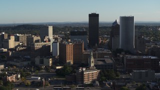 DX0002_209_005 - 5.7K aerial stock footage circling an apartment building near high-rises, Downtown Rochester, New York