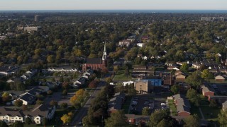 DX0002_209_017 - 5.7K aerial stock footage wide orbit of brick church in Rochester, New York