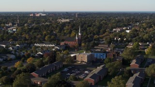 DX0002_209_018 - 5.7K aerial stock footage slow orbit of brick church in Rochester, New York