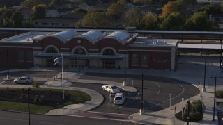 5.7K aerial stock footage fly away from and orbit a brick train station at sunset in Downtown Rochester, New York Aerial Stock Footage | DX0002_209_024