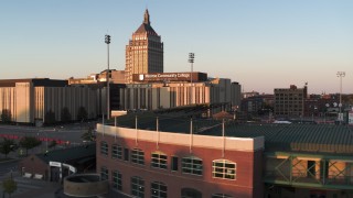 DX0002_209_035 - 5.7K aerial stock footage fly over Frontier Field toward college and Kodak Tower at sunset, Rochester, New York