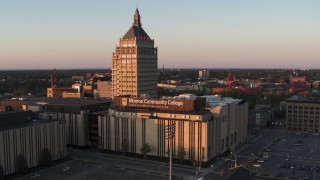 DX0002_209_039 - 5.7K aerial stock footage of orbiting Kodak Tower and a college at sunset, Rochester, New York