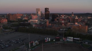 5.7K aerial stock footage reverse view of a radio tower and office buildings at sunset, Downtown Rochester, New York Aerial Stock Footage | DX0002_209_051