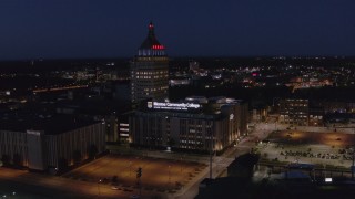 DX0002_210_036 - 5.7K aerial stock footage fly away from Kodak Tower and college at night, and descend, Rochester, New York