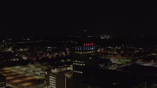 DX0002_210_052 - 5.7K aerial stock footage orbit around Kodak Tower at night, Rochester, New York