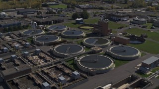 DX0002_211_016 - 5.7K aerial stock footage of orbiting a sewage treatment plant in Syracuse, New York