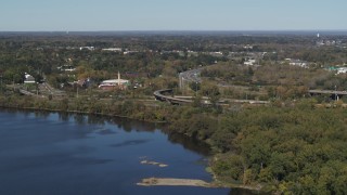 5.7K aerial stock footage of flying away from the State Route 370 interchange by the lake in Syracuse, New York Aerial Stock Footage | DX0002_211_040